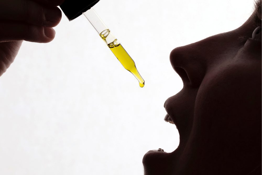 Woman taking cbd oil